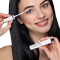 Dark haired woman holding the mascara to her lashes